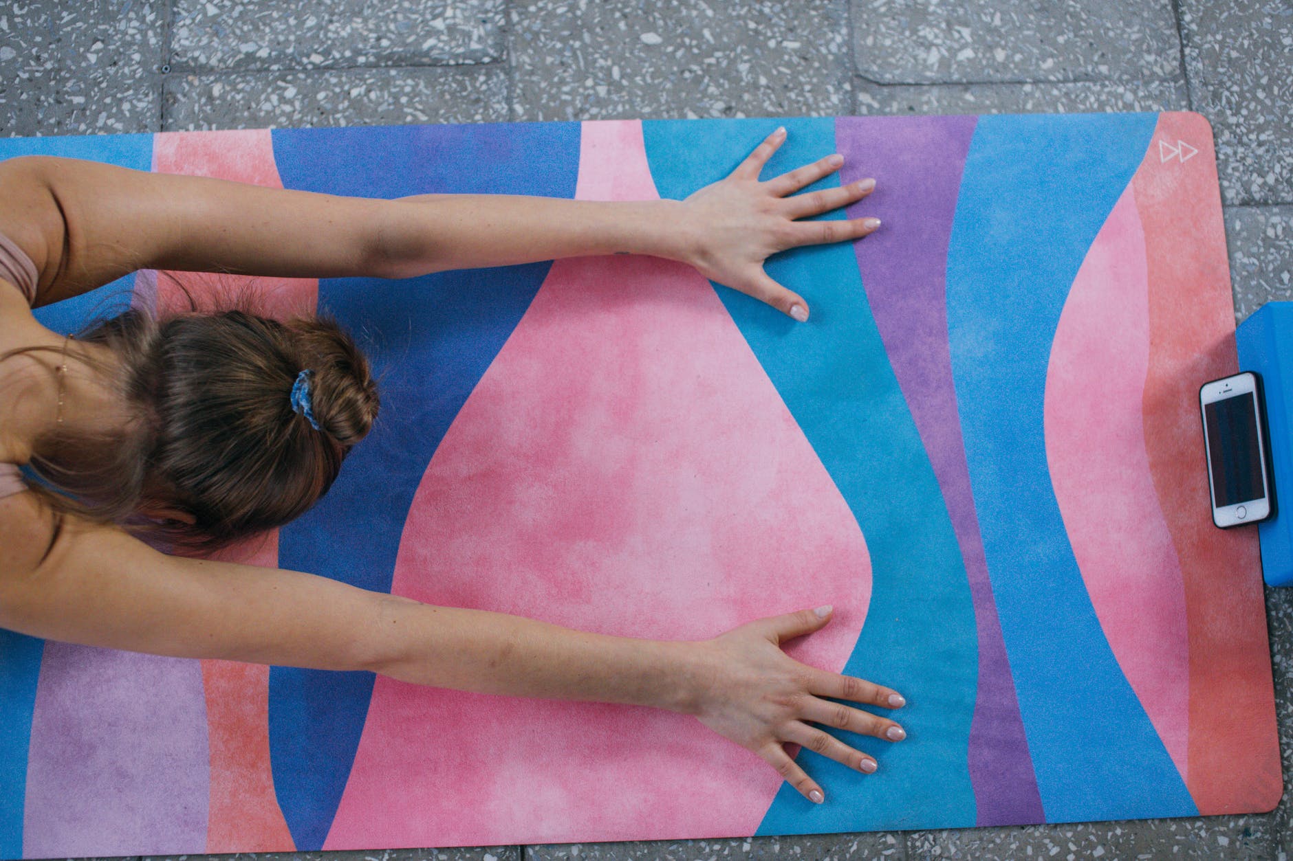 woman lying on pink mat