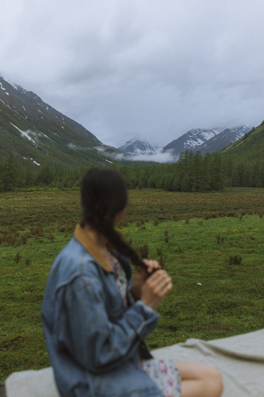 a woman looking to the mountains